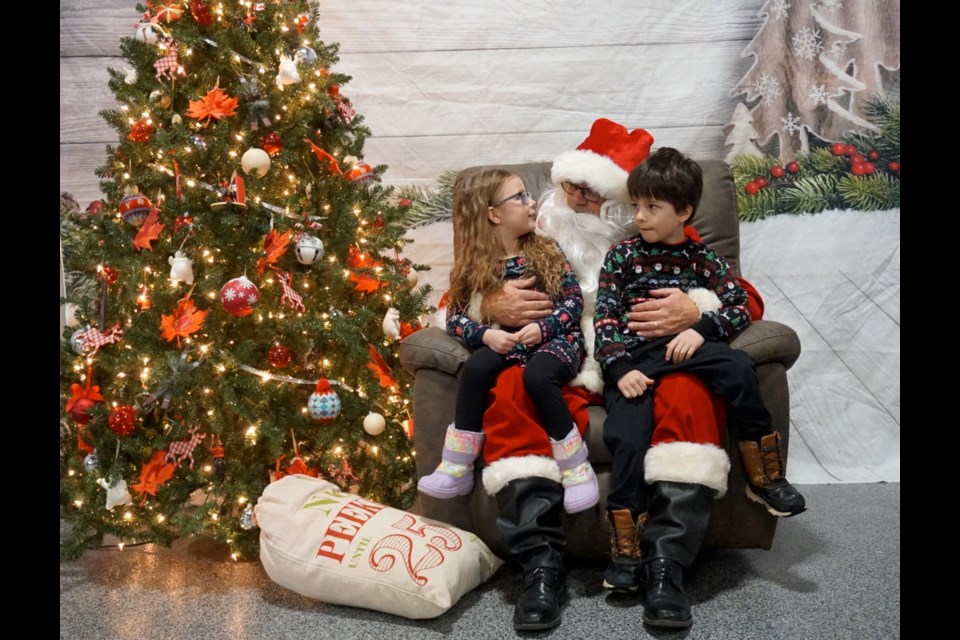 Santa carefully listened to Charlotte and Quade Mathison's Christmas wishes.                              