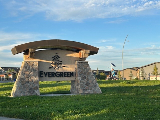 The welcome sign into Saskatoon's Evergreen neighborhood showcases the trees that were part of the naming inspiration.
