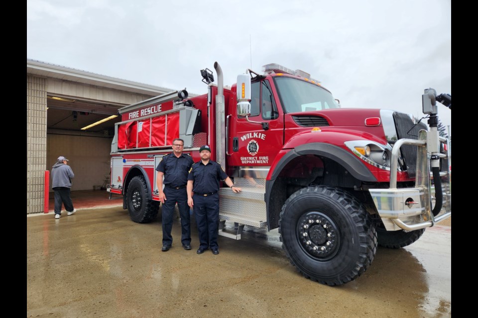 Wilkie Fire Chief Randy Elder and Deputy Fire Chief Craig Sittler proudly stand beside the newest truck added to the WDFD firefighting fleet.