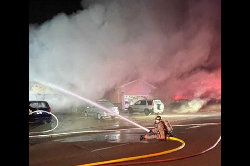 Rescue workers helped free a person trapped in the backyard at house fire 3100 block of 37th Street West on Sunday.
