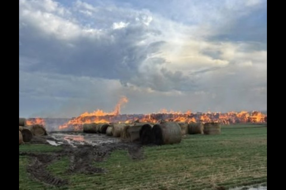 Flames sweep through bale piles near Macklin after a lightning strike, as seen in photos shared by the Macklin Fire Department.