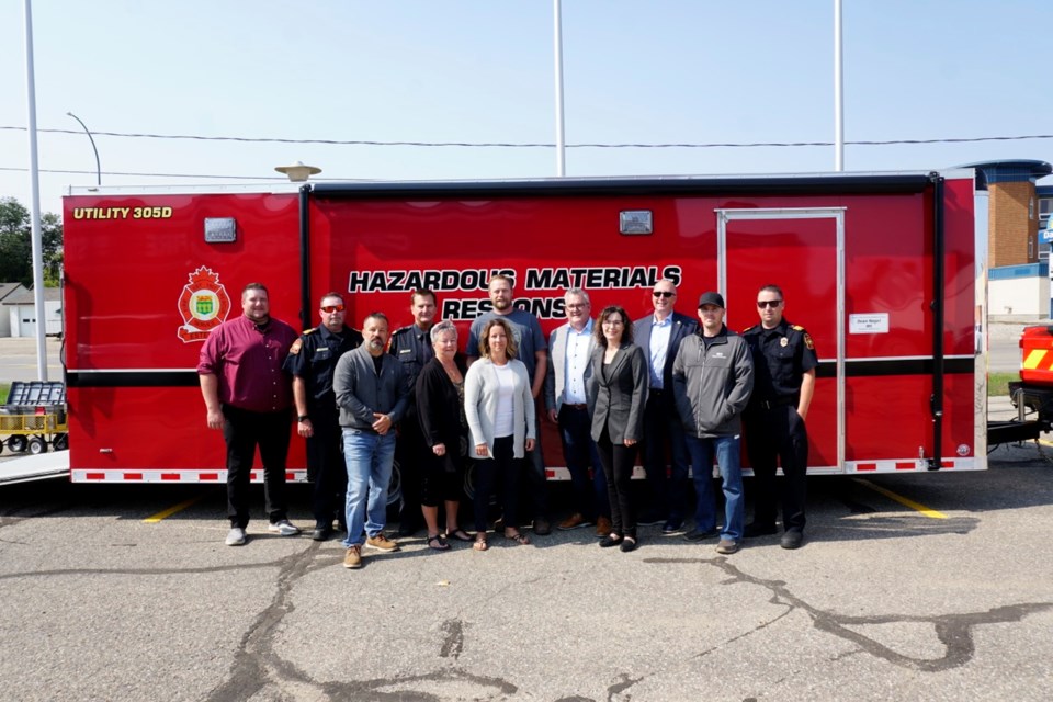 The Estevan Fire Rescue Service introduced the latest addition to its fleet. Participating in the presentation of the hazardous materials response trailer, commemorating the late firefighter Dean Nagel were, back row, from left, city manager Jeff Ward, Fire Chief Rick Davies, Capt. Peter Fedyk, the president of the Estevan Firefighters Association; Lance Locken, director, SaskPower, Shand Power Station; Kevin Armstrong, vice-president of operations, Kingston Midstream; Mayor Roy Ludwig and Deputy Fire Chief Kyle Luc. Front row, Dean Nagel's son Trevor Nagel, wife Bev Nagel and daughter Becky Kuntz; Dena Bachorcik, public awareness and community investment co-ordinator for Kingston Midstream; and Ben Brokenshire, inventory manager and fleet co-ordinator with Kingston Midstream and firefighter with the EFRS.