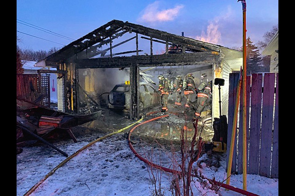 Saskatoon firefighters inspect the garage to make sure the fire was completely put out.