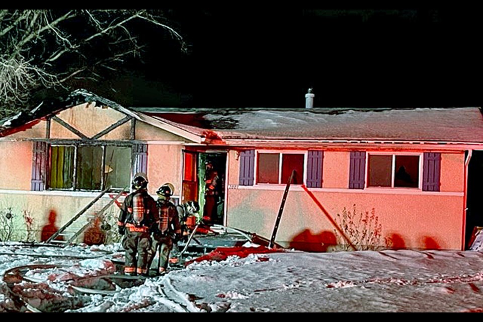 Saskatoon firefighters survey the house to make sure the structure is no longer on fire.