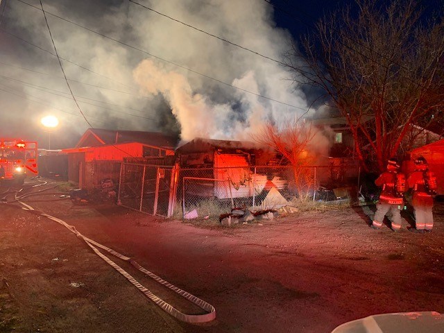 Fire crews, right, assess the condition of the fire before moving in. 