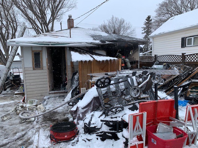 Various items littered the yard of the house that caught fire in the 900 block of Avenue L North.