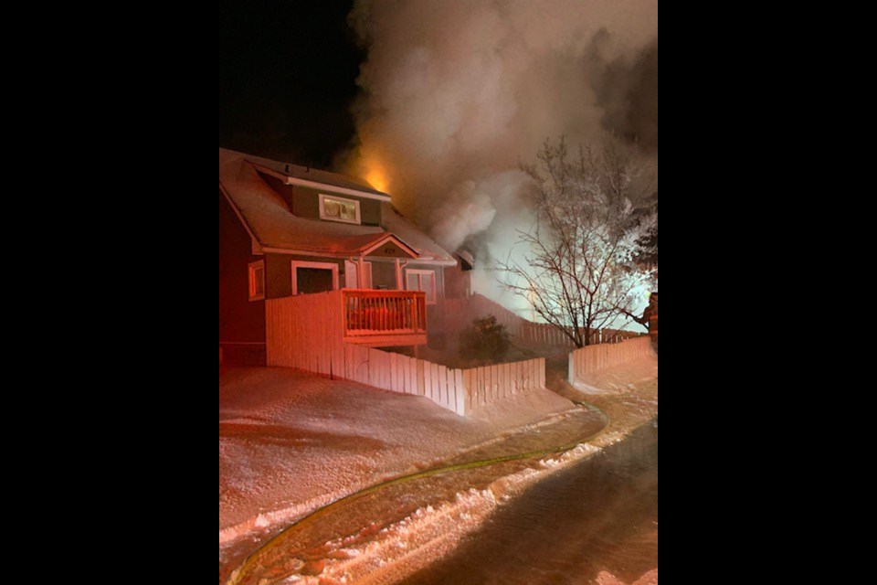 Fire and smoke can be seen coming out of a house in the 400 block of Avenue R South.