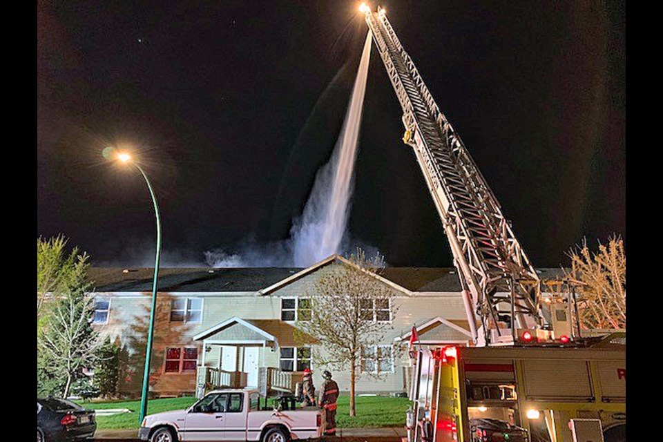 Fire crews attack the exterior of the housing units that were involved in the fire.
