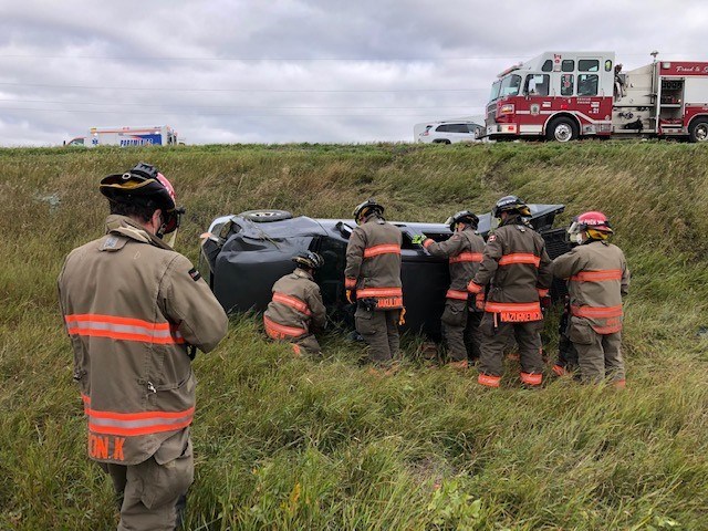 Saskatoon Fire Department crews work to remove a patient inside the vehicle that rolled over on Highway 14 Thursday morning.