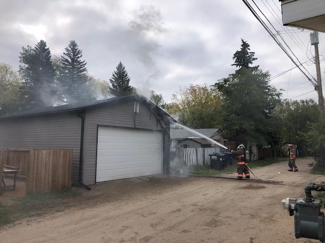Saskatoon Fire Department crews try to put out a garage fire in the 800 block of Avenue I South Thursday morning.
