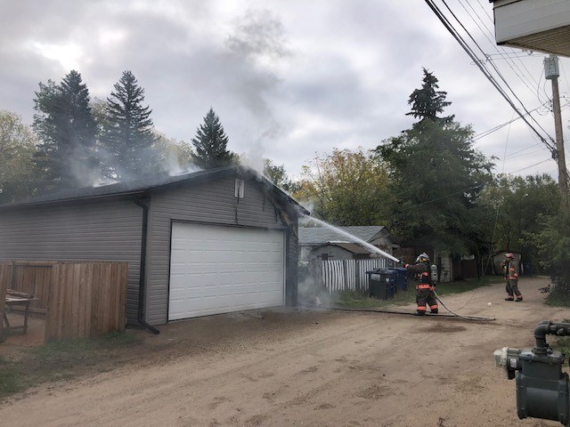 Saskatoon Fire Department crews try to put out a garage fire in the 800 block of Avenue I 鶹Ƶ Thursday morning.