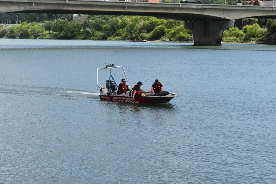 Members of the Saskatoon Fire Department water rescue unit patrol the Saskatchewan River.
