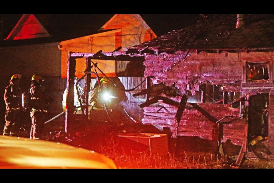 Weyburn fire fighters ensured the fire that destroyed this garage was completely out, late Sunday evening behind a home on Seventh Avenue South in Weyburn