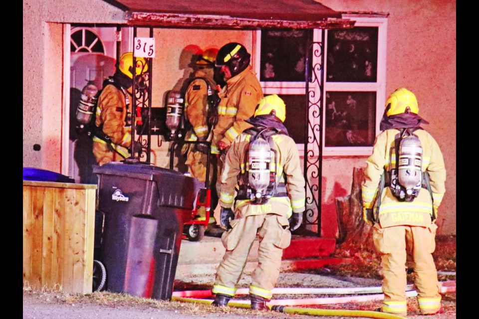 Weyburn fire fighters exit the home as fresh members were ready to go in and continue fighting the fire inside.