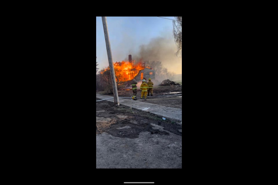 A home is fully engulfed in flames, resulting in a total loss, from a fire May 5 in the village of Tramping Lake.