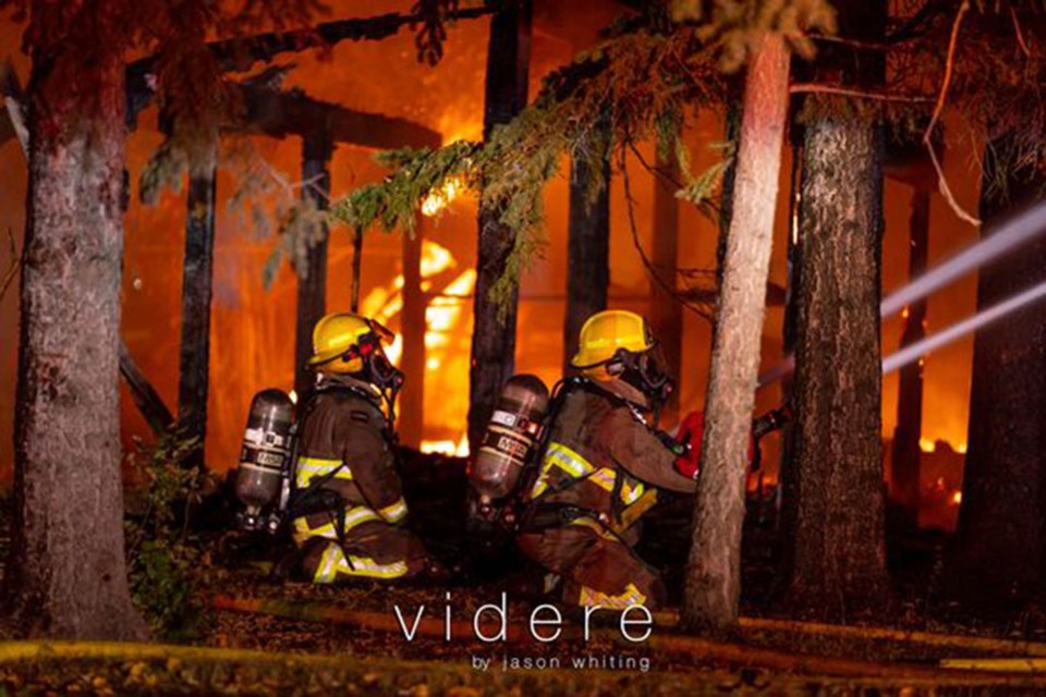 Lloydminster firefighters battle a fire north of the railway tracks along Highway 17 Tuesday night. 