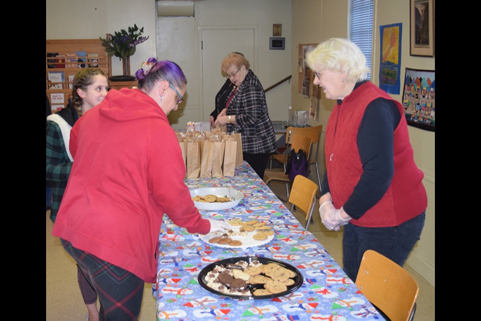 Judy Schick (right) was one of the United Church Lades answering questions and provided  useful information about the many different types of cookies.