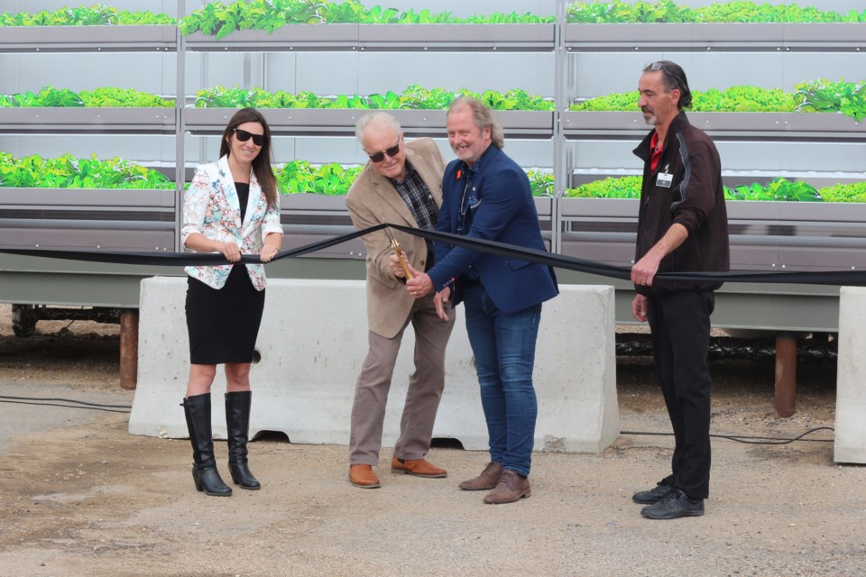 Legacy Co-op  Finance Manager Katie Hull, Board President Clark Anderson, Mayor Mitch Hippsley and Legacy Co-op Produce Manager Stew Winter cut the ribbon at the grand opening of the Neighbourhood Fresh Modular Farm.