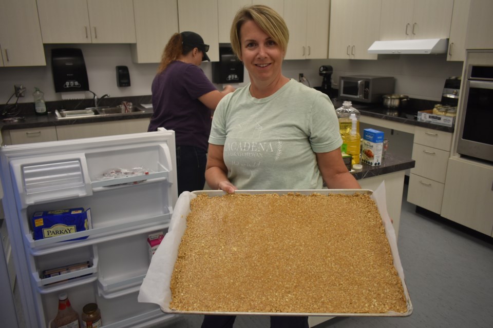 Reagan Foster a local farmer and parent, displayed the large tray of granola bars, a favourite among students, created for the breakfast program.