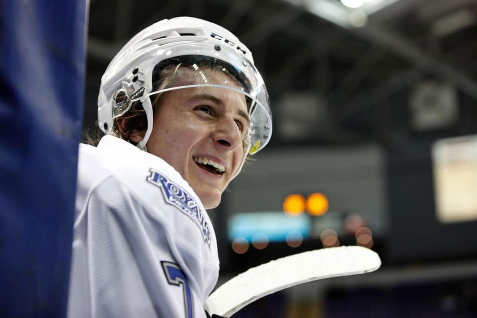 All smiles watching the game, Cole Reschny cheers on his teammates from the bench.