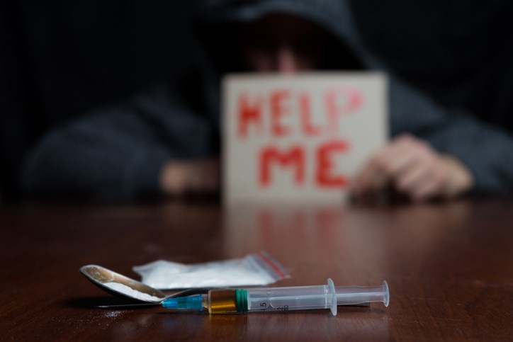 A drug addict sign help