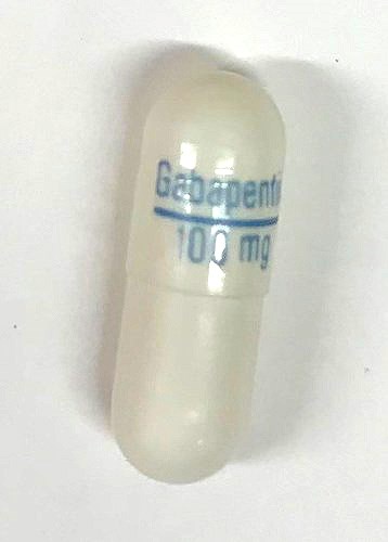 Riva-Gabapentin 100 mg capsules - white hard gelatin capsules, with Gabapentin / 100 mg printed on the capsule in blue ink.