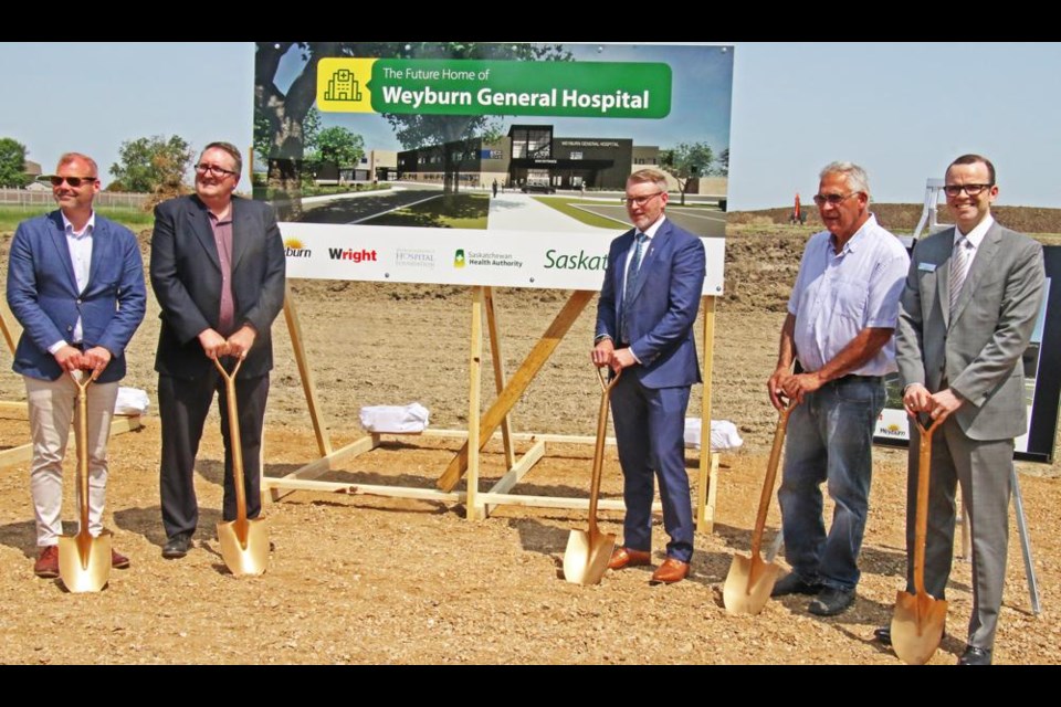 Weyburn-Big Muddy MLA Dustin Duncan, Hospital Foundation chair Jeff Hayward, Rural and Remote Health Minister Everett Hindley, Mayor Marcel Roy and COO of the Sask. Health Authority Derek Miller lined up to do the official ground-breaking for Weyburn's new hospital on Monday.