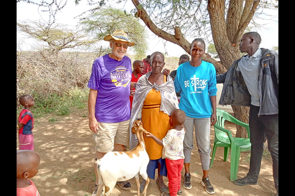 Pictured are Vic Hamer, President of Give Me Water Lord, a local Kenya woman and her son who received the gift of a goat, and Jane Ntaoti, Field Representative for GMWL. The Ebenezer Baptist Church has funded 32 goats though this organization.