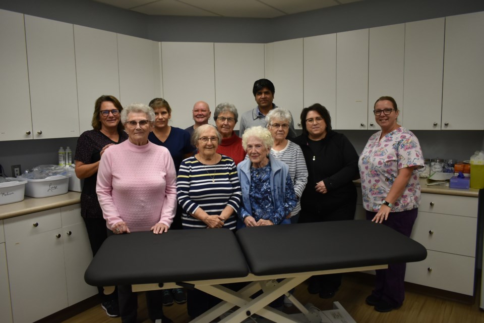 The Assiniboine Valley Medical Centre staff gathered for a photo with the Kamsack Hospital Auxiliary along with the new bed purchased with their donation.