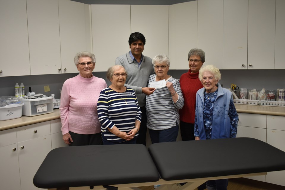 Members of the Kamsack Hospital Auxiliary came together with Dr. Sri Prassana as they presented him with the cheque for a new medical bed. From left were, Betty Salahub, Denise Wishnevetski-Grozik, Dr. Sri Prassana, Dianna Belovanoff; President of the Kamsack Hospital Auxiliary, Marge Popoff, and Betty Fedorak.