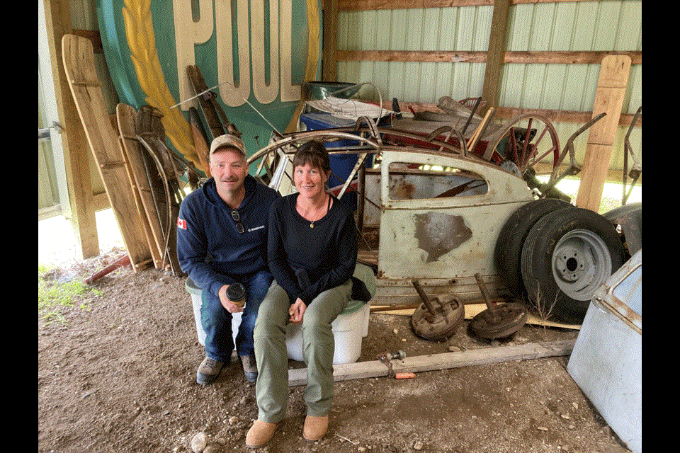 Lisl Gunderman and her husband Darrell Hunter, sitting with their discovery of the remains of The Delivery Wagon.