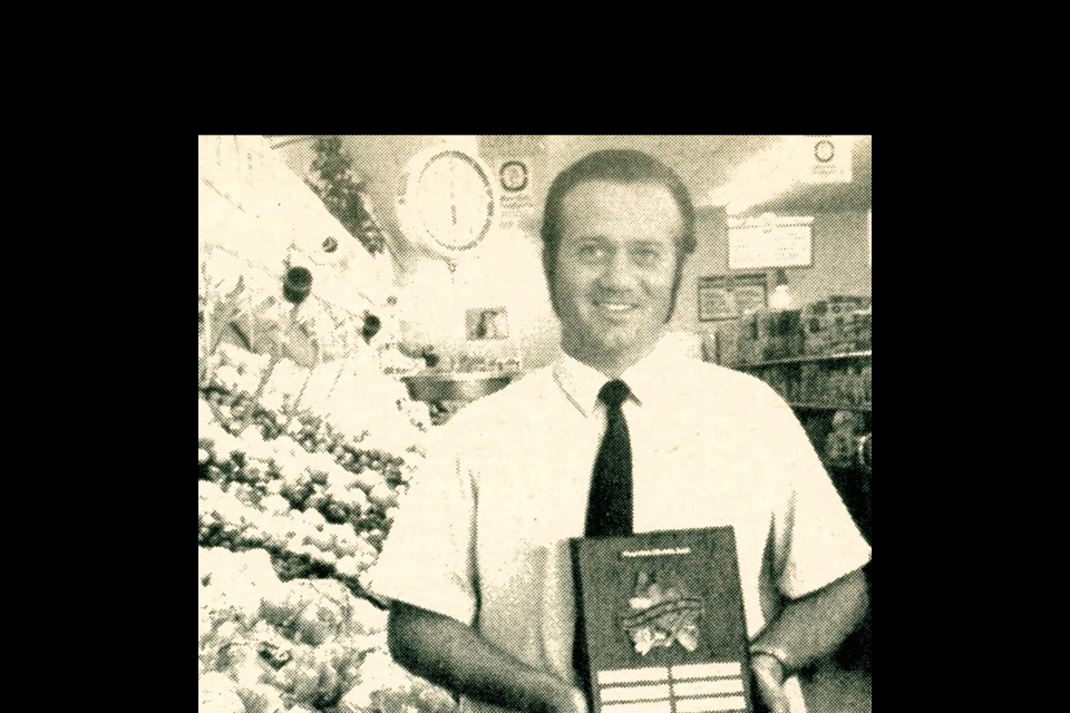 Unity Tomboy Store General Manager, Franklin Mann, poses with the Western Grocers Produce Award in Sept. of 1972, won for excellence in displaying fruit and vegetables.