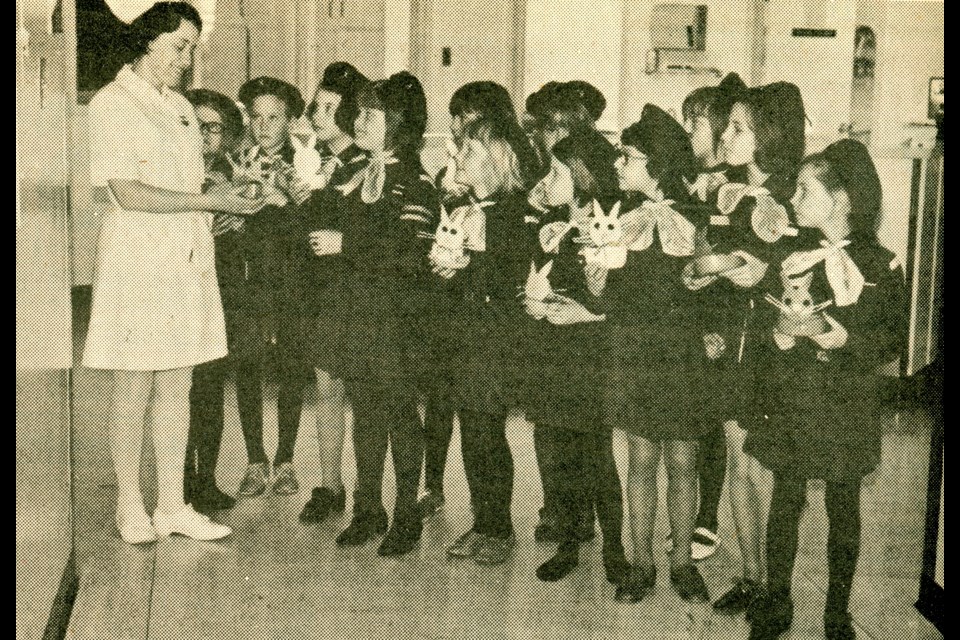 Brownies Shannon Wood, Darlene Barth, Connie Boutin, Diana Maljan, Sylvia Clarke, Lynn Thiessen, Sheri Maljan, Maureen Wood, Janice Urlacher, Janet Duscherer, Charlene Wildeman and Karen Wildeman present Eaters baskets they created to RN, Mrs. Prediger, at Unity Union Hospital.