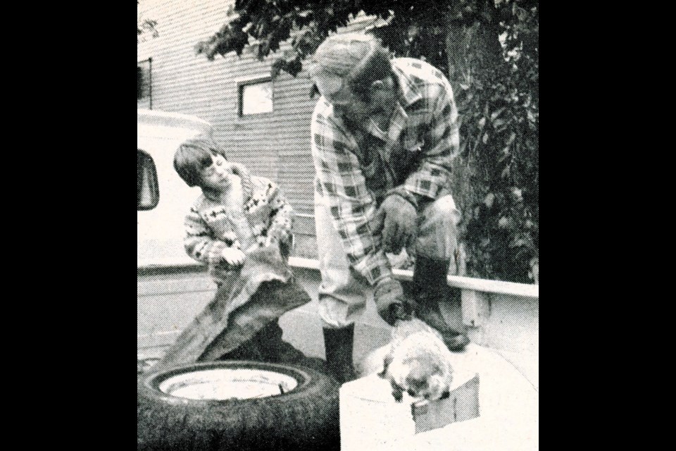 Scott farmer Bill Risling and his young son with their new pet, a woodchuck. Risling caught the woodchuck, considered “an unusual item in these parts,” in a wooded area on the farm acreage. (Wilkie Press archives)