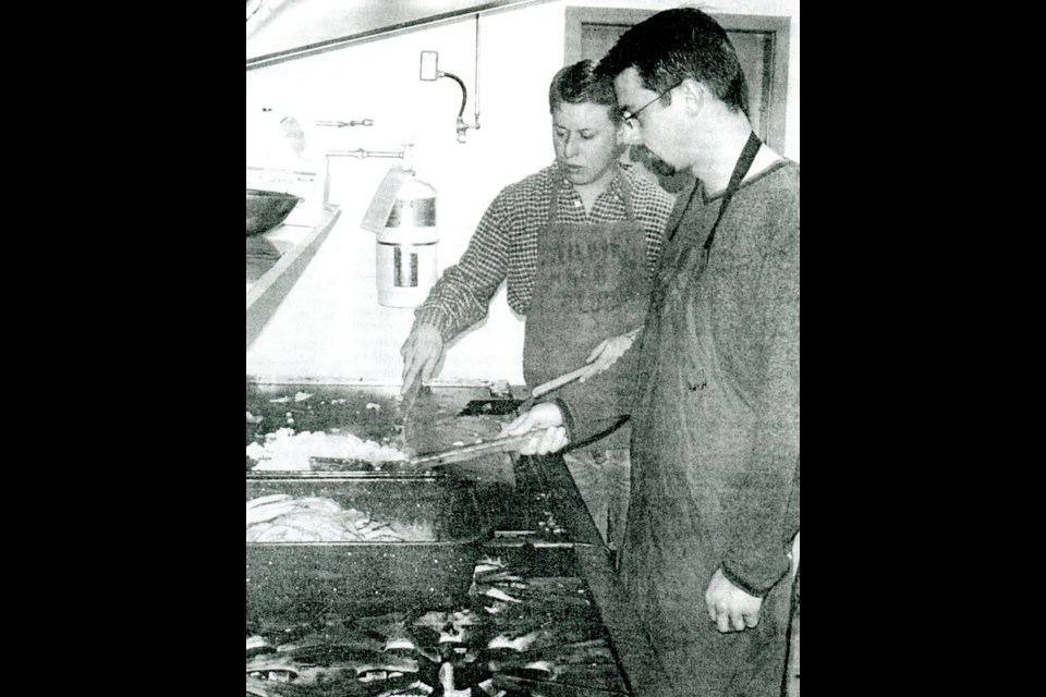 Wilkie Kinsmen members Greg Gutting and Joey Reiniger scramble eggs and flip pancakes for the 2003 Wilkie Farmer’s Days pancake breakfast.