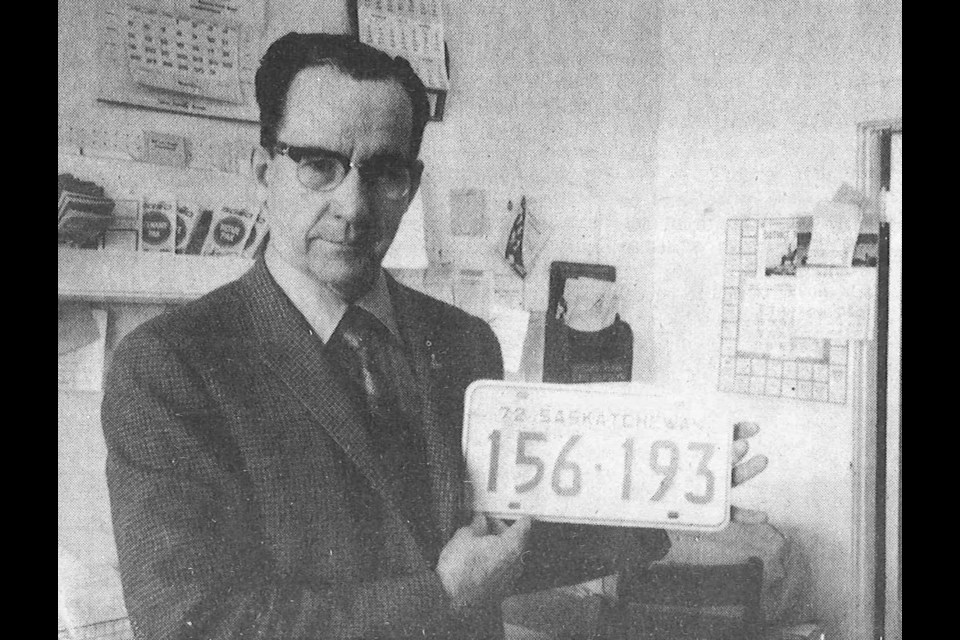 The new 1972 licence plates were on sale at local vendor Haight and Young. George Young displays one of the new plates which bears the same serial sequence as in 1971. The new plates were light blue on a white background with the letters appearing in fluorescent paint.
