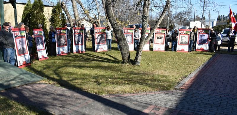 The sponsor families for each Norquay Veteran Banner stood in a semi-circle at Bell Park until it was their turn to present both sides of the completed banner to the attending witnesses.