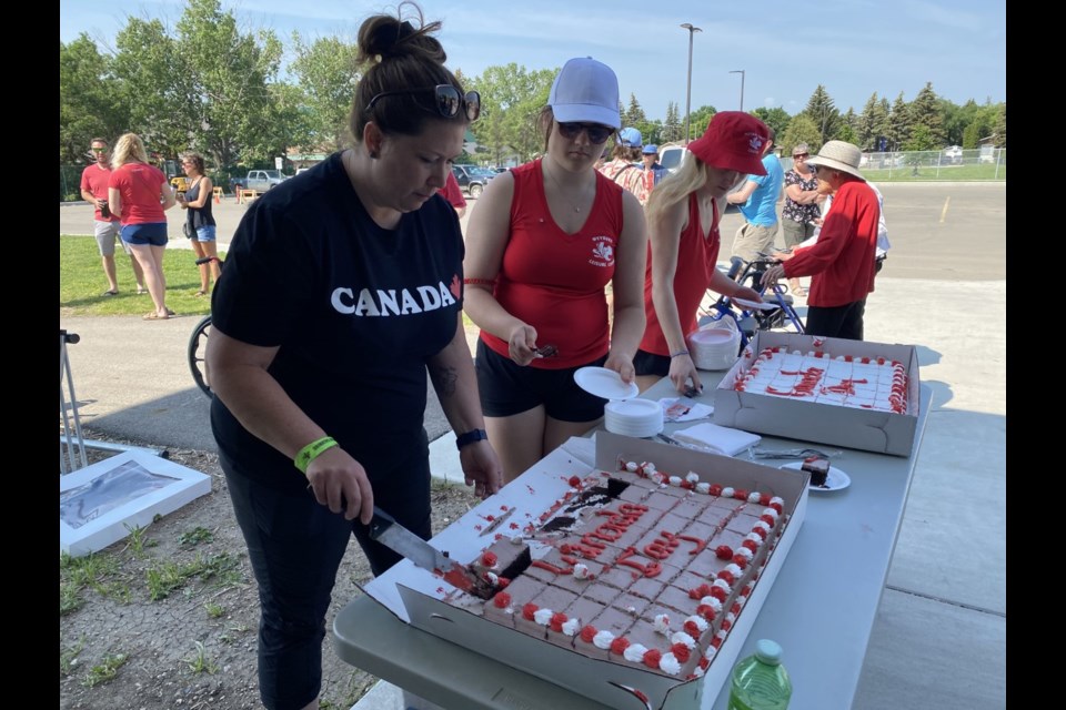 Leisure Centre staff cut a Canada Day cake at the Spark Centre.
