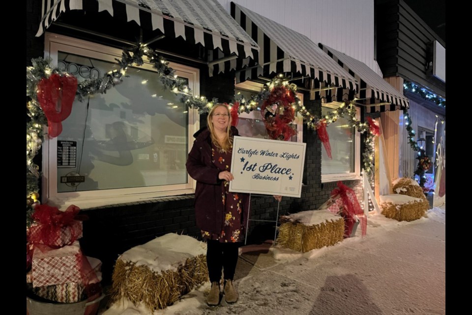 Mayor Jenn Sedor at the site of the best-decorated business, the Lotus Tree. 