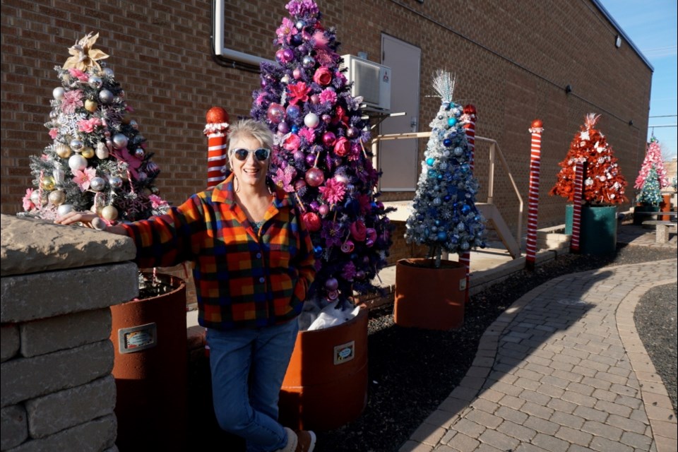Gale Tytlandsvik and her crew of helpers installed and decorated many Christmas trees in the Garden on Fourth for the holiday season.