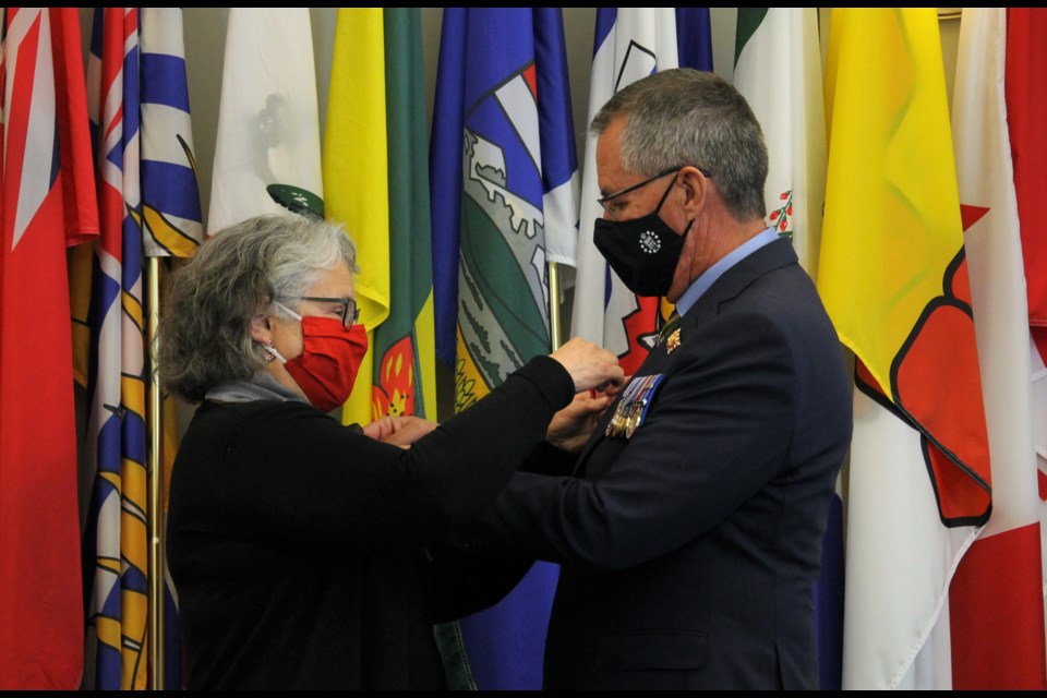Lieutenant-Governer Russ Mirasty (R) and Donna Mirasty (L) pinned the first poppies of the 2021 campaign to each other.
