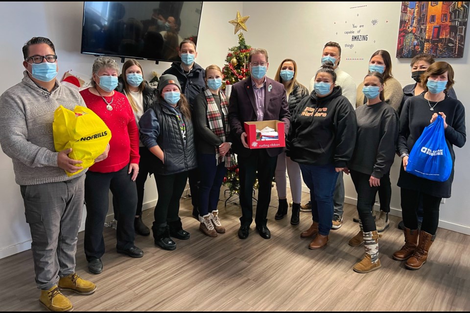 Representatives from BATC, BTC, the Metis Nation of Sask., and staff from Miywasin Kikanow shelter celebrate the announcement of the RCMP's Cram a Cruiser donation drive with Cst. Ryan O'Hara and North Battleford Mayor David Gillan, on Friday, Dec. 2