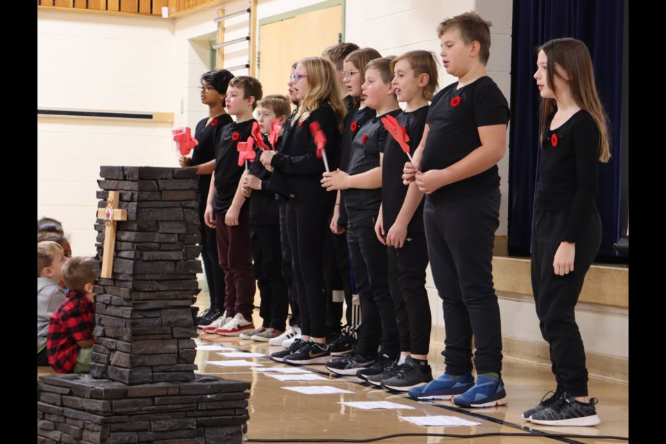 Mrs. Manning’s Grade 5 reads 'In Flanders Fields' during a Remembrance Day service held at Assiniboia Park Elementary School