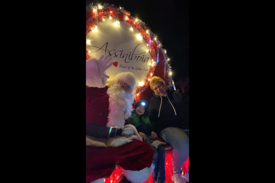 Santa rides along with TJ VandeSype and Mayor Sharon Schauenberg during the annual Christmas Light Parade, held in Assiniboia on December 6.