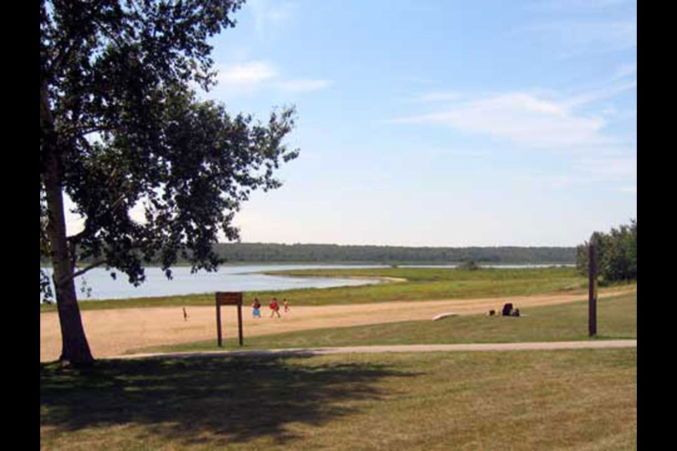 Low water levels can be seen from the beach at Kenosee Lake. 
