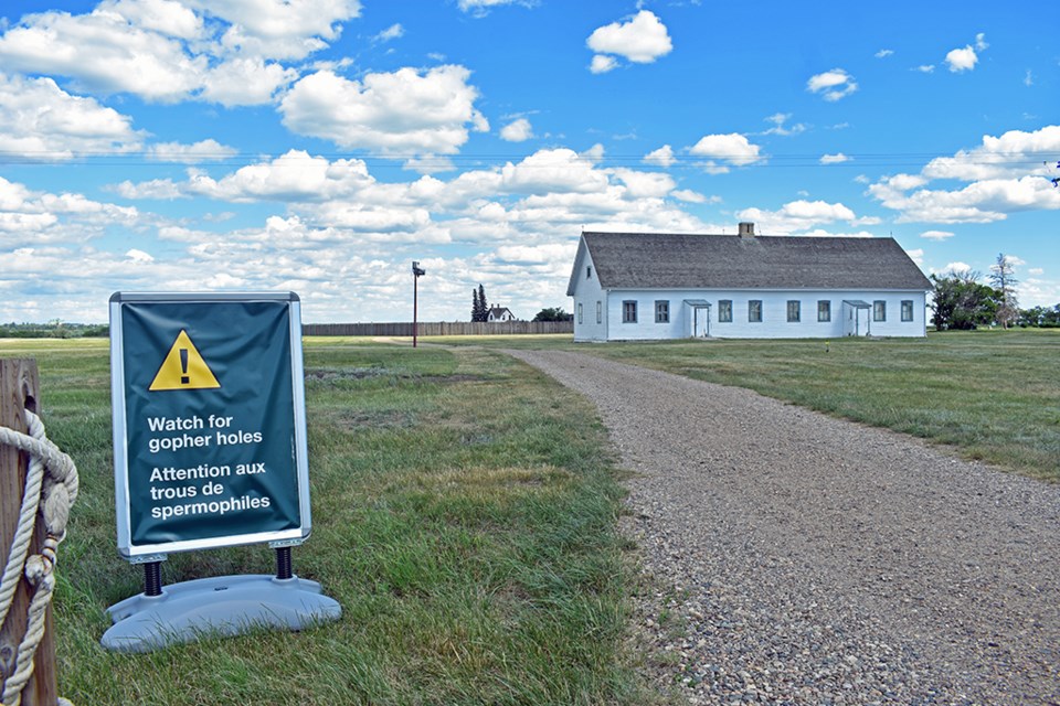 A sign at the walkway entering Fort Battleford National Historic Site warns of the gopher holes proliferating the grounds.