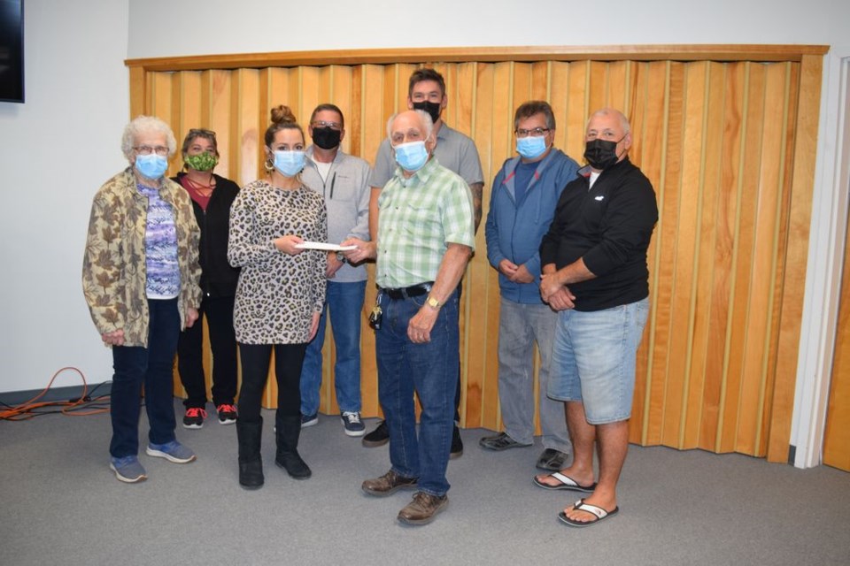 On behalf of the Canora Ukrainian Heritage Museum committee, Bernard Marchinko (president) and Dorothy Korol (treasurer) presented a cheque for $1,000 for the ongoing maintenance of the Canora Lesia Welcome Statue to The Planning and Development Department, represented by Brandi Zavislak, at the Town Council meeting on October 5. From left, were: (back row) Councillors Jacqueline Fetchuk and Eric Sweeney, Mayor Mike Kwas, Councillors David Wasyliw and Brad Gabora; and (front) Korol, Zavislak and Marchinko. / Rocky Neufeld  

