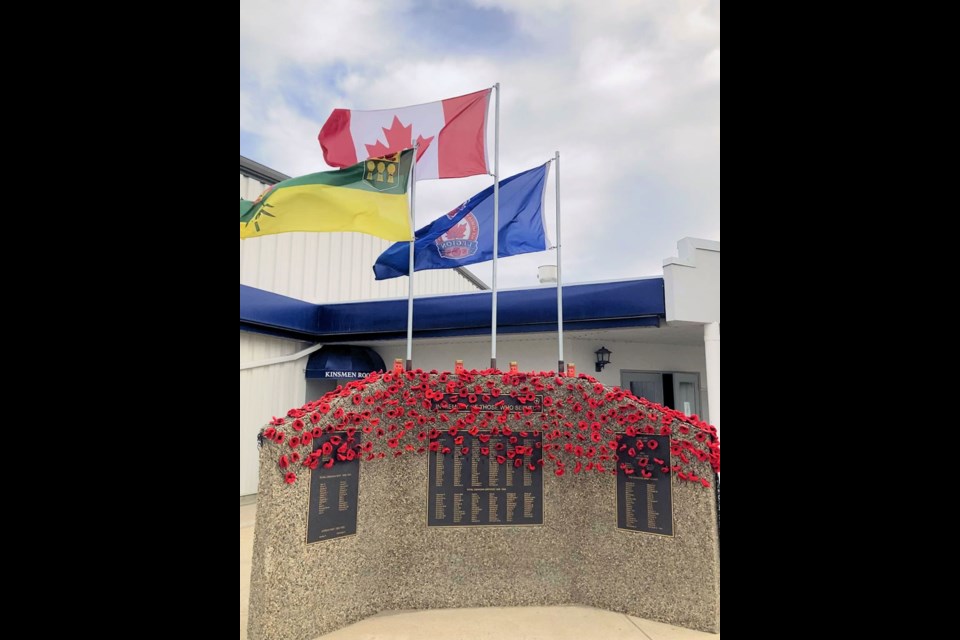 Crocheted poppies lay on top of the memorial of those who served from the Macklin area.