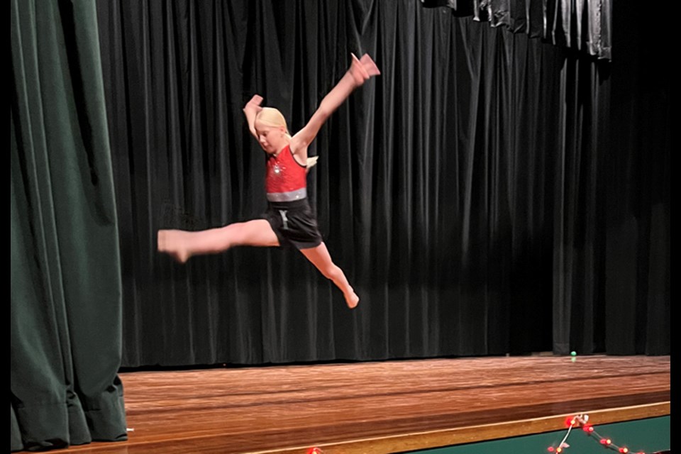 Emily takes to the air during a gymnastics routine.  