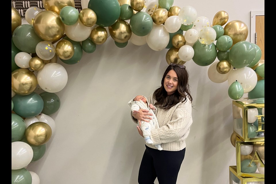 Taylor Kowalsky holding six-week-old Maverick Kowalsky Sunday afternoon at his baby shower.